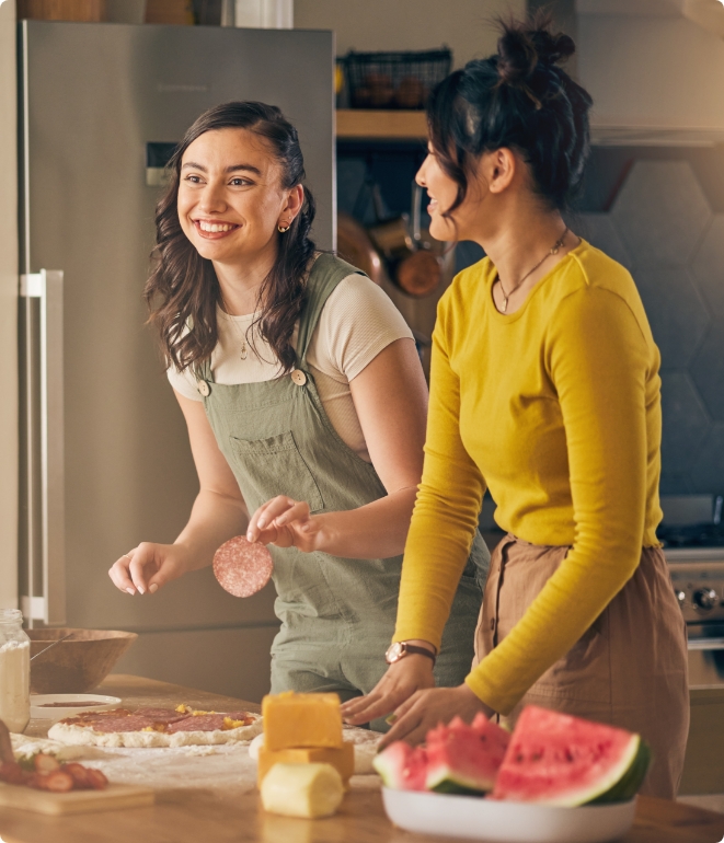 Two people in the kitchen enjoying the warm air from their boiler installation.